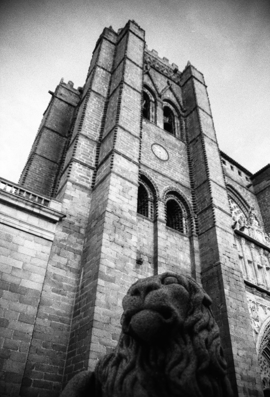  View of the belfry of the cathedral, protected by a stone lion, in Ávila, Spain (c) pmartinasi