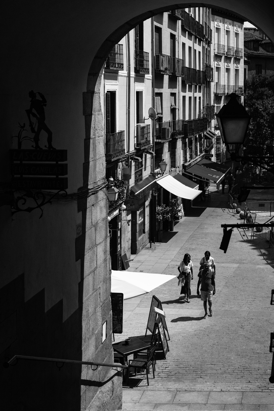  Summer street scene at Puerta de Cuchilleros steps leading to Plaza Mayor in Madrid, Spain. (c) pmartinasi