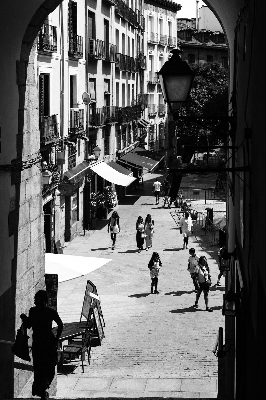  Summer street scene at Puerta de Cuchilleros steps leading to Plaza Mayor in Madrid, Spain. (c) pmartinasi
