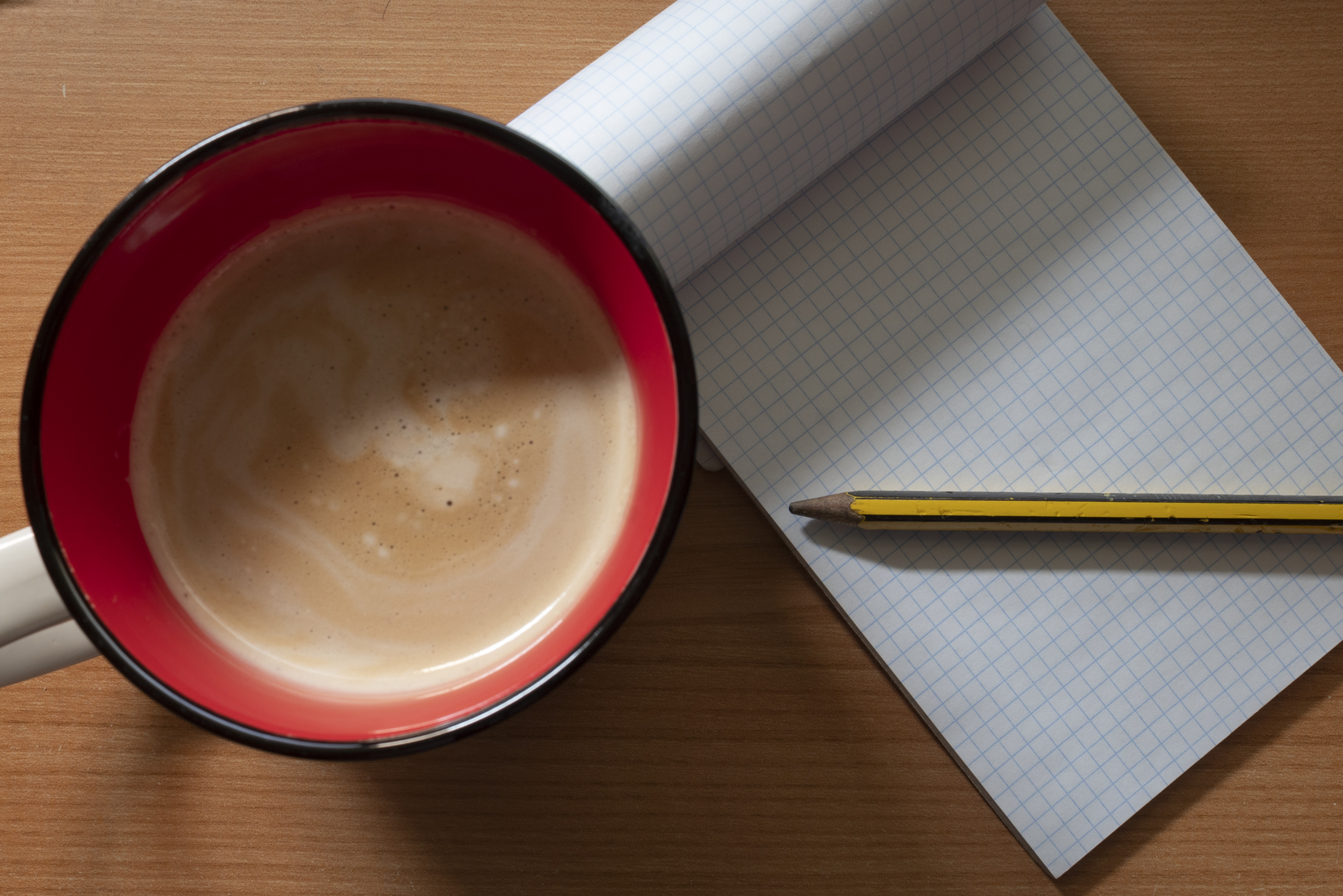  Morning Productivity Setup with Coffee and Blank Notebook on Wooden Table. (c) pmartinasi