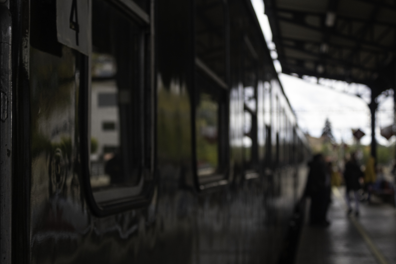  The historic Felipe II train stopped at El Escorial station. The green vintage carriage reflects the station's architecture and soft twilight ambiance, highlighting timeless railway heritage. (c) pmartinasi