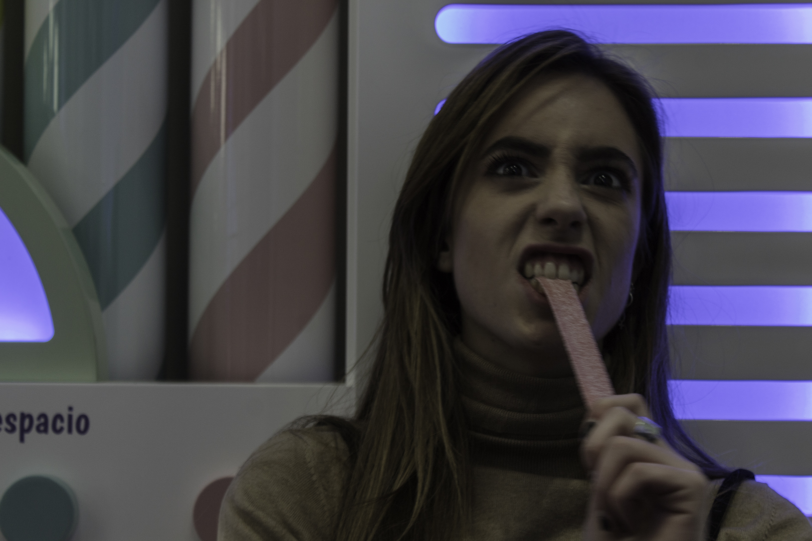 Woman Enjoying a Sweet Treat in a Colorful Candy-Themed Setting. (c) pmartinasi