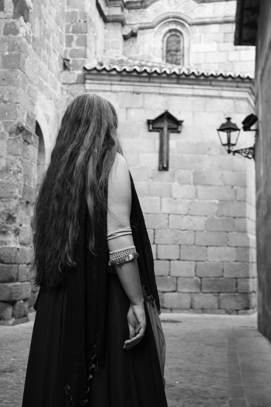 Young girl, with her back turned, at the Medieval Market at Avila, Spain (c) pmartinasi