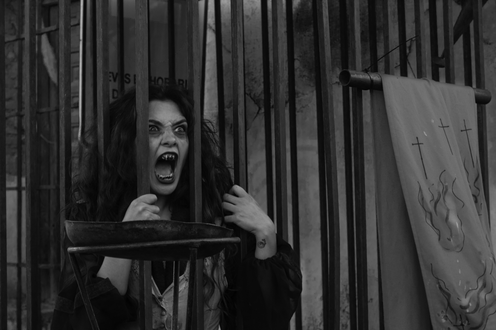 Imprisoned witch at a haunted alley, full of stinkers, in the medieval market and fair of Oropesa, Toledo, Spain. (c) pmartinasi