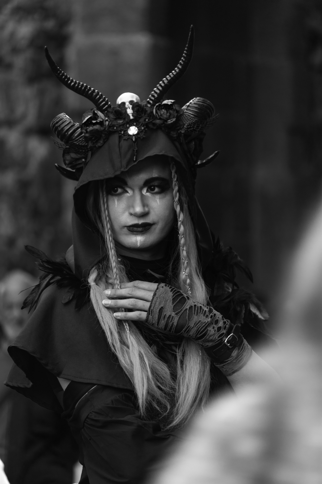  A shadow rises from the ancient stone—horned, veiled in feathers, crowned with roses and bone. This is no mere mortal, but a myth reborn at the Medieval Fair of Ávila. A vision of gothic power and forgotten magic, captured in monochrome majesty. Medieval Market and Fair in Ávila. September 2025. (c) pmartinasi