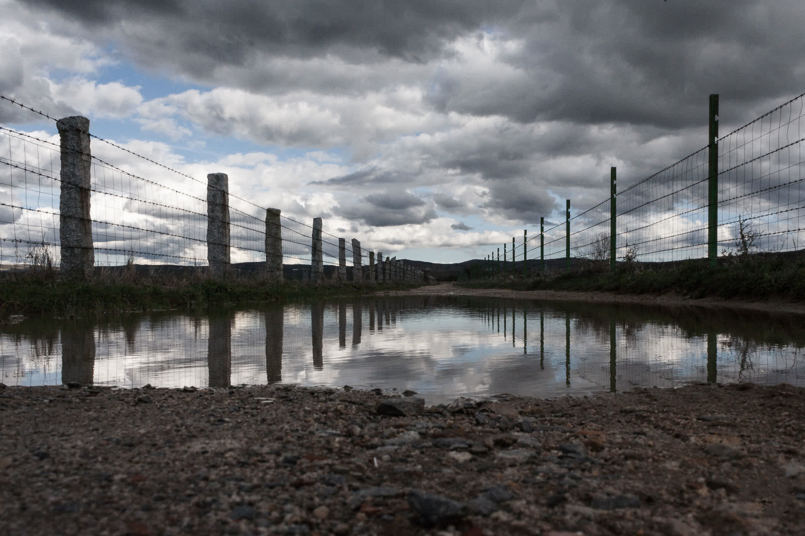 Puddle in the middle of the dirt path (c) pmartinasi