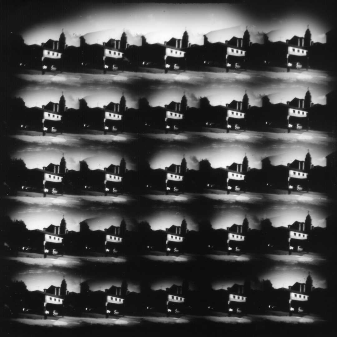 A captivating black-and-white photographic collage featuring repetitive silhouettes of an urban skyline at dusk. The artistic arrangement of the 35 pins of the pinhole camera creates a surreal, cinematic effect with strong contrasts and moody tones. Camera design by @joterman. (c) pmartinasi
