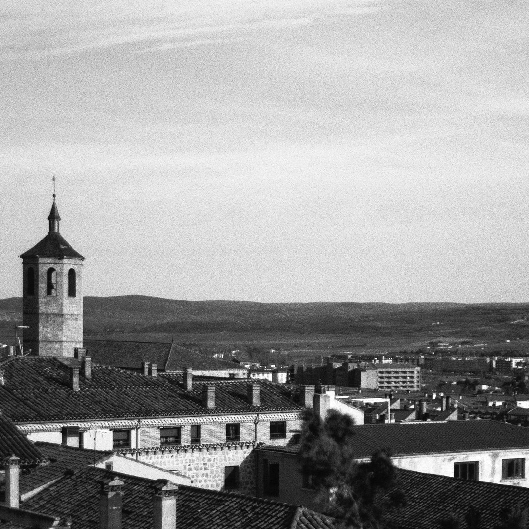  Panoramic view of the southern part of Ávila, dominated by the unmistakable bell tower of the Church of Santiago, in Ávila, Spain. (c) pmartinasi