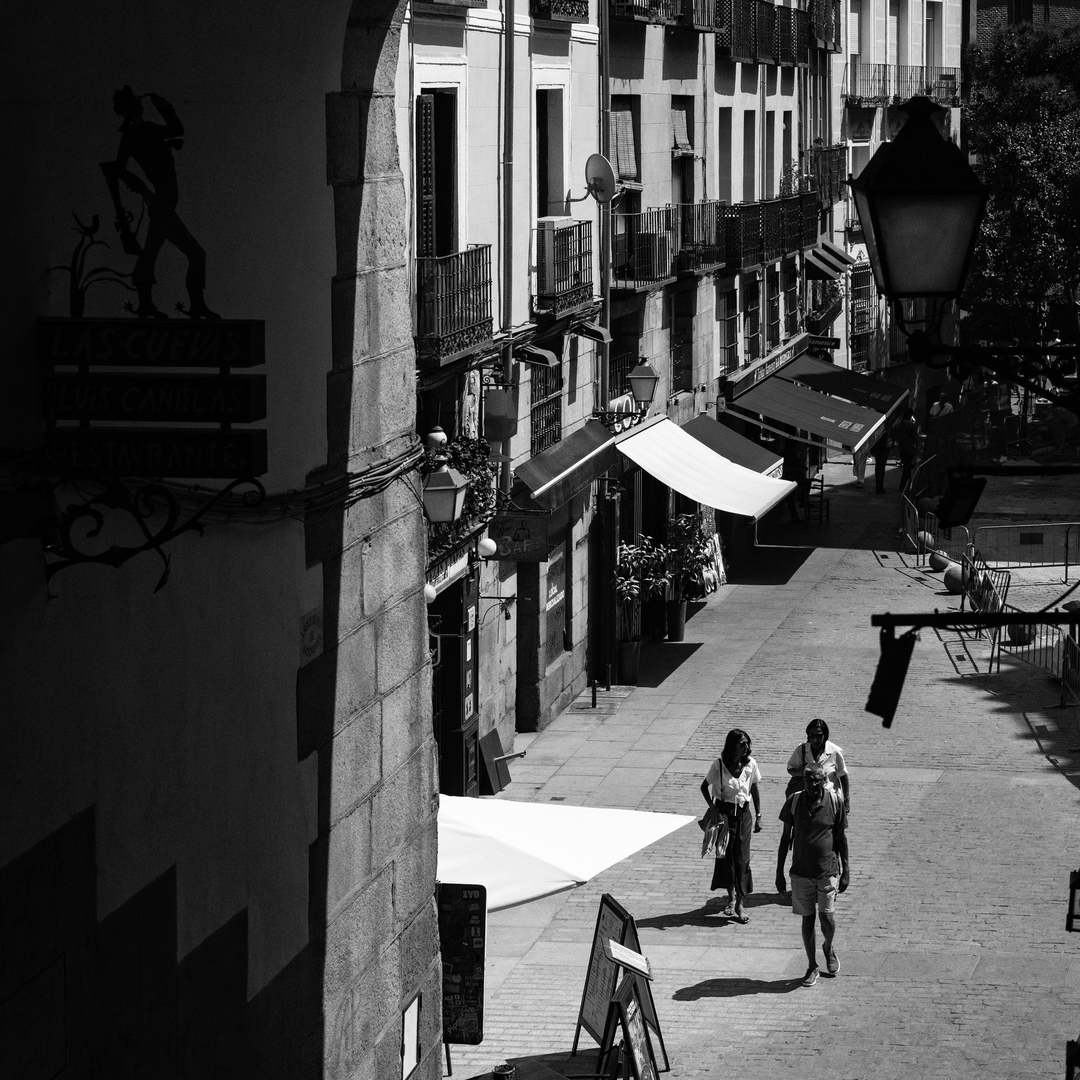  Summer street scene at Puerta de Cuchilleros steps leading to Plaza Mayor in Madrid, Spain. (c) pmartinasi