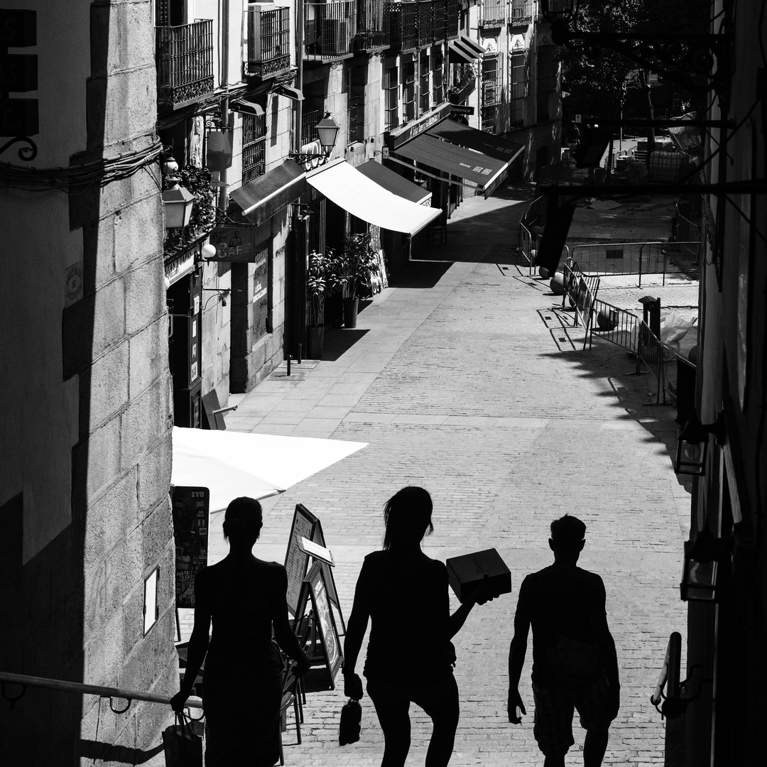  Summer street scene at Puerta de Cuchilleros steps leading to Plaza Mayor in Madrid, Spain. (c) pmartinasi