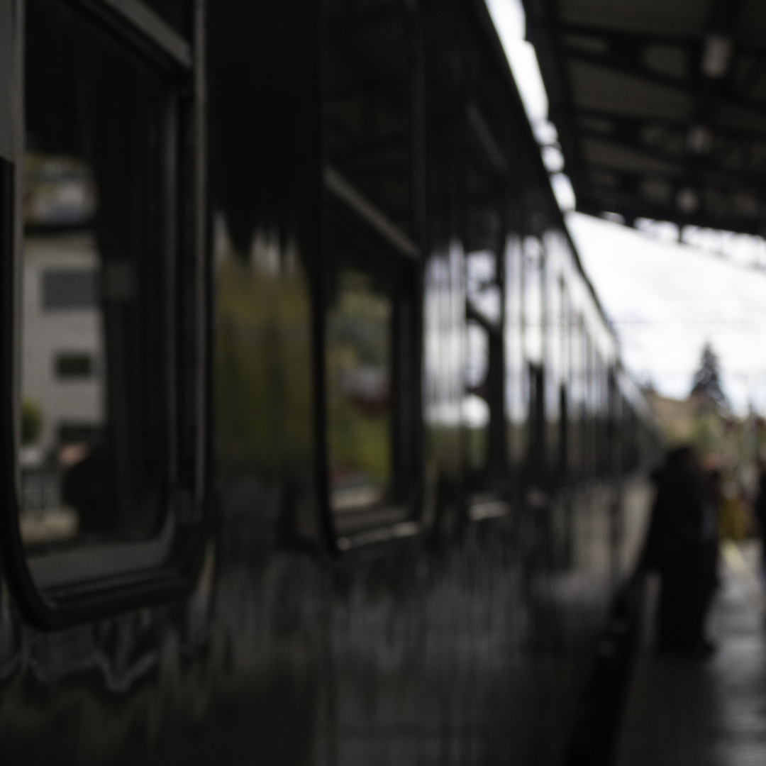 The historic Felipe II train stopped at El Escorial station. The green vintage carriage reflects the station's architecture and soft twilight ambiance, highlighting timeless railway heritage. (c) pmartinasi