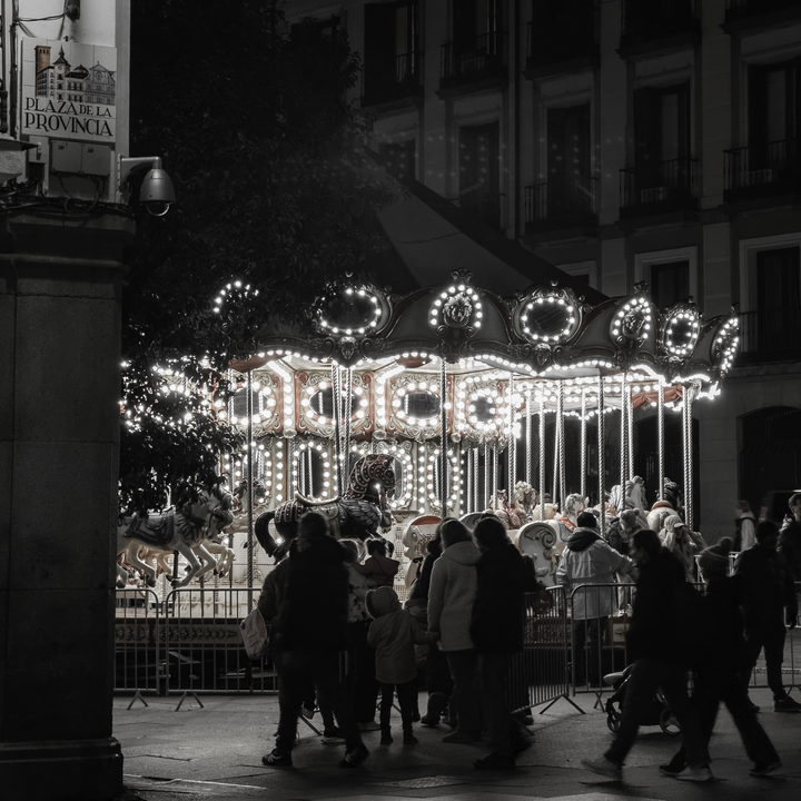  Christmas merry-go-round lighting up Plaza de la Provincia in Madrid at night. (c) pmartinasi