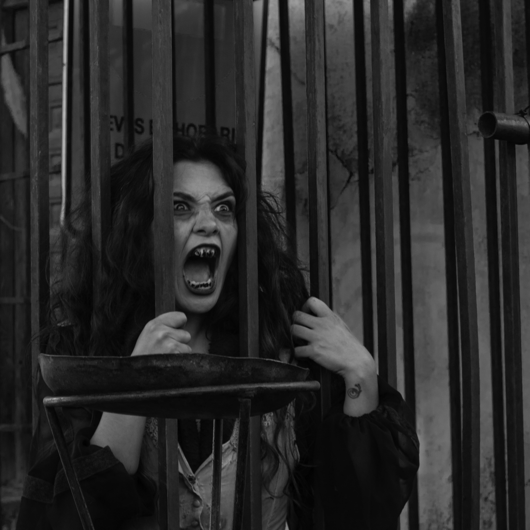 Imprisoned witch at a haunted alley, full of stinkers, in the medieval market and fair of Oropesa, Toledo, Spain. (c) pmartinasi
