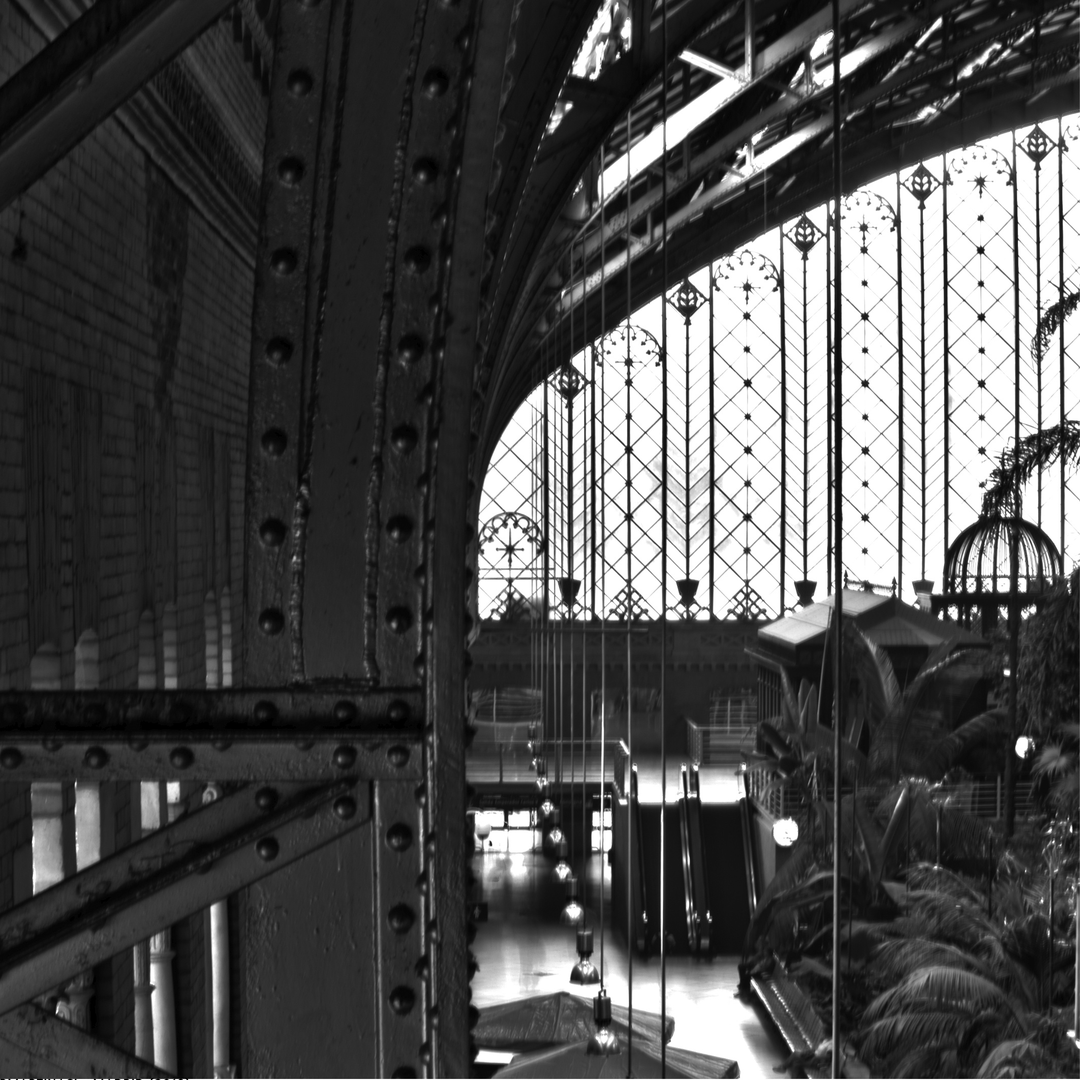  Classic black and white photo of the iconic Puerta del Sol Metro sign with the historic clock tower behind, capturing the spirit of central Madrid and its architectural charm. (c) pmartinasi