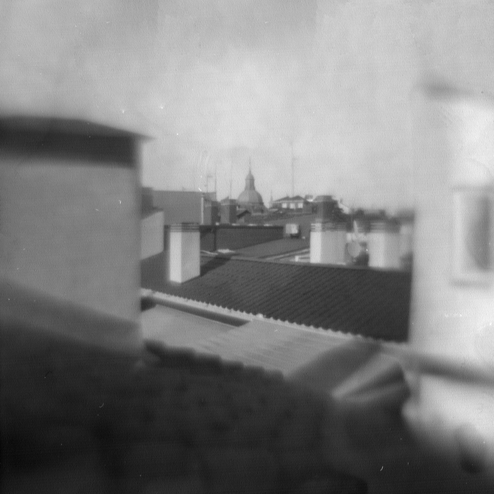 Ethereal pinhole camera cityscape of Madrid, Spain, featuring the iconic dome of the Convent of the Comendadoras de Santiago with soft light and blurred details.